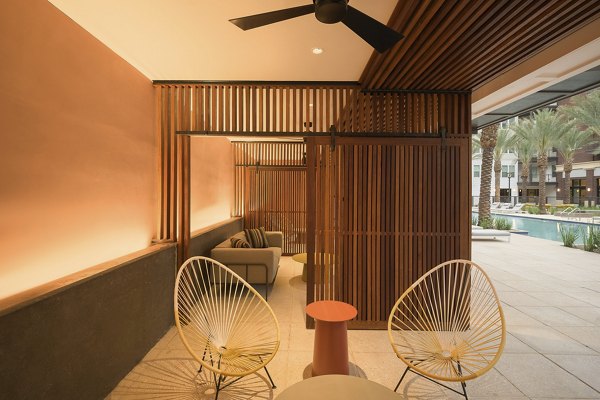 Cozy outdoor patio with modern seating at The Tyler Apartments, offering a luxurious space for relaxation in a vibrant community setting