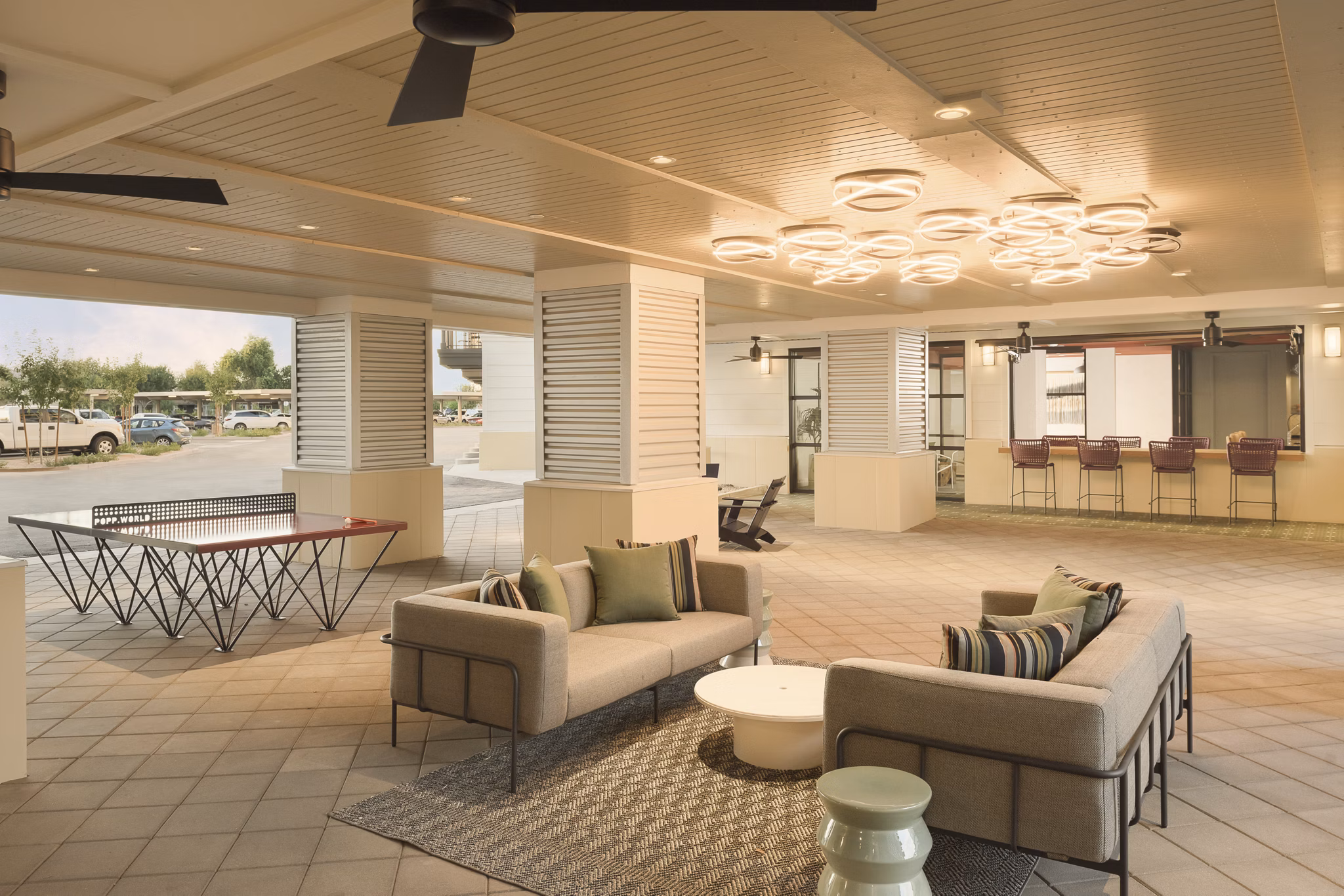 Patio with modern furniture and lush greenery at The Tyler Apartments