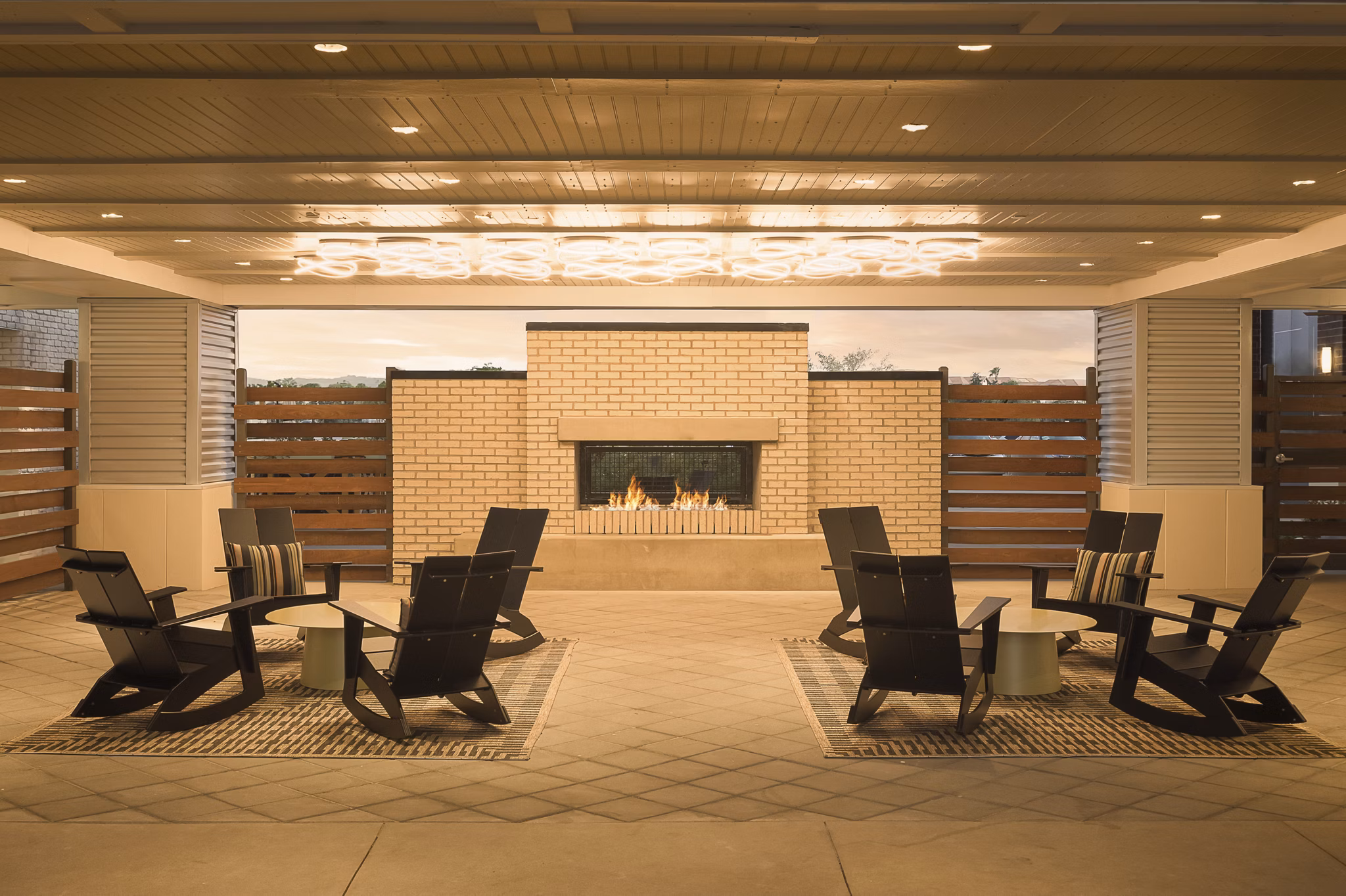 Fire pit with cozy seating area at The Tyler Apartments, offering luxury amenities in a serene setting