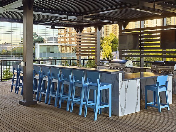 Grill station with seating area at Generation Atlanta Apartments, perfect for outdoor gatherings and barbecues