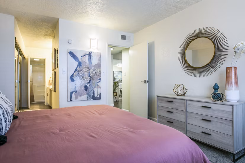 Tranquil bedroom with contemporary furnishings at Stride West Apartments, perfect for luxury living in a serene setting