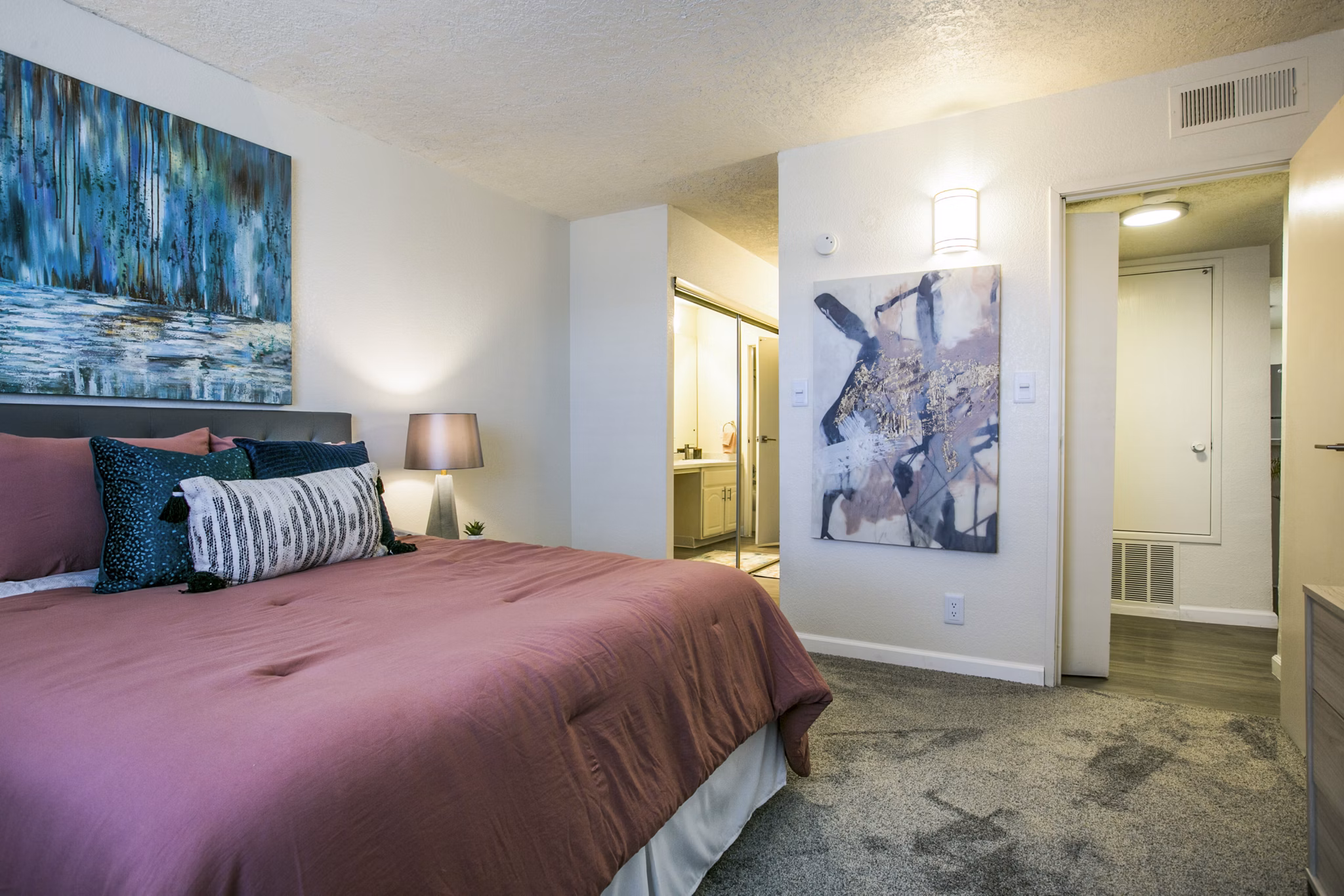 Cozy bedroom with modern furnishings at Stride West Apartment, luxury living by Greystar