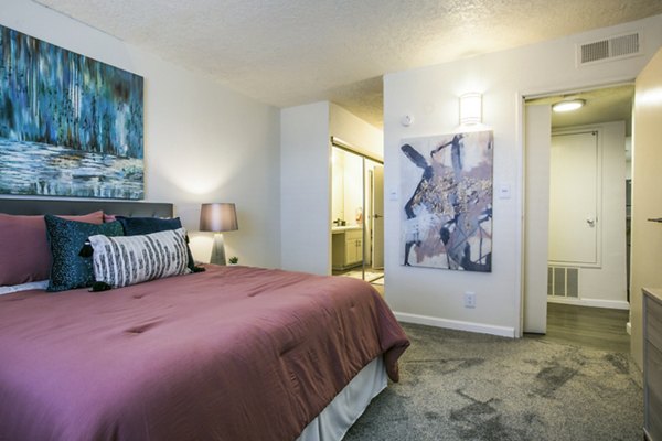Cozy bedroom with modern furnishings at Stride West Apartment, luxury living by Greystar