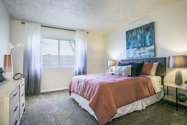 Cozy bedroom with modern decor in Stride West Apartment