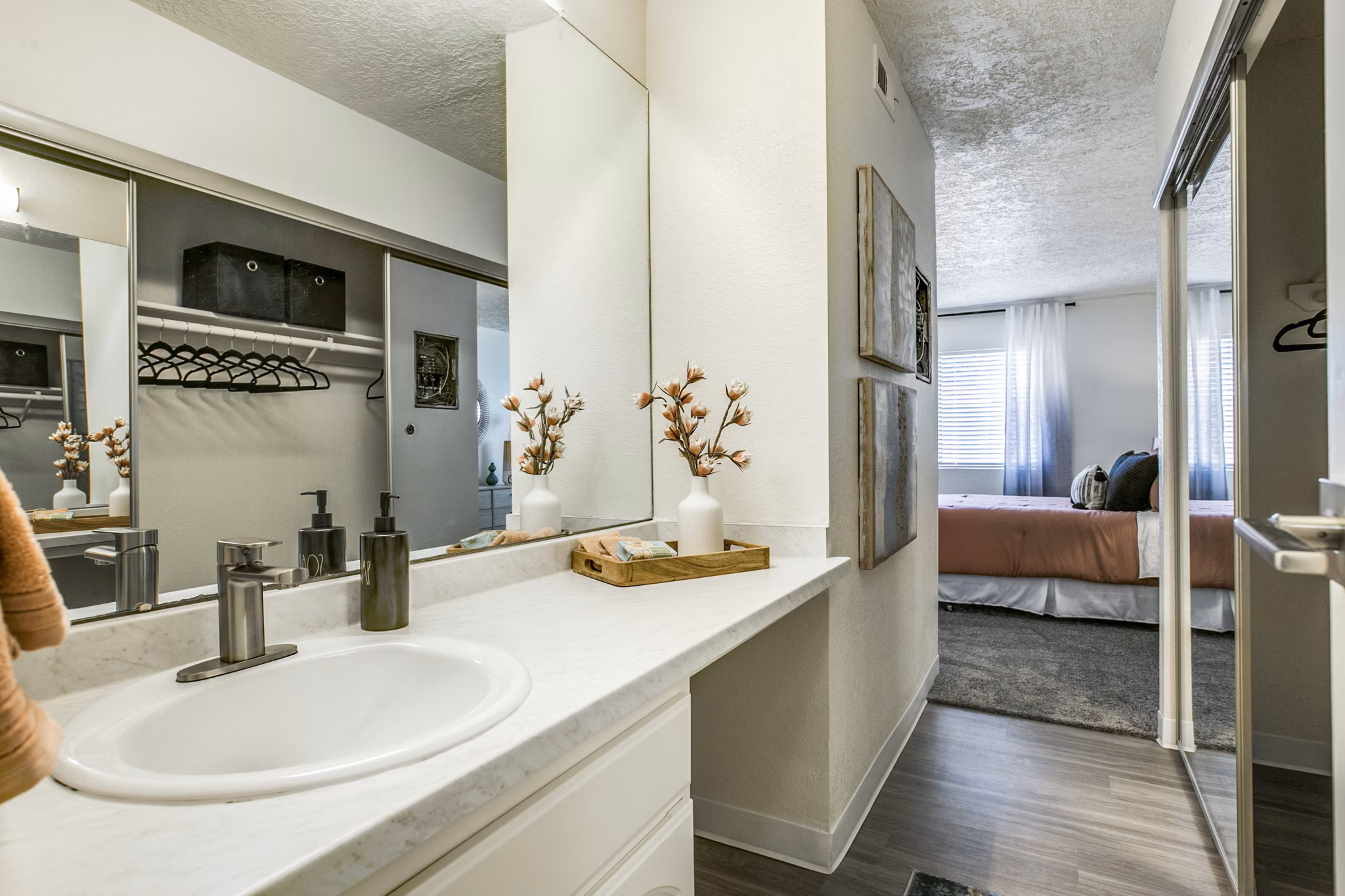 Modern bathroom with sleek fixtures and large mirror at Stride West Apartments, offering luxury living amenities in a vibrant community