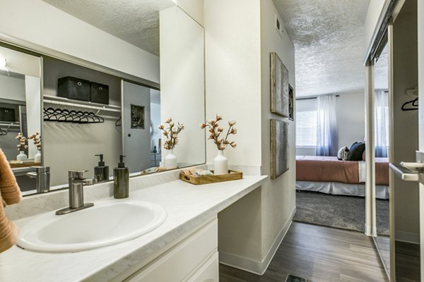 Modern bathroom with sleek fixtures and large mirror at Stride West Apartments, offering luxury living amenities in a vibrant community