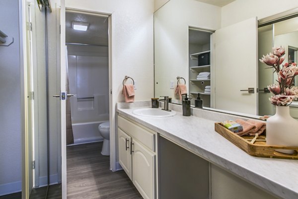 Modern bathroom with sleek fixtures and ample lighting at Stride West Apartments
