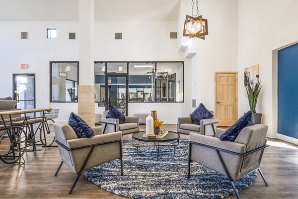 Clubhouse featuring modern design and ample seating at Stride West Apartments, a luxury community by Greystar