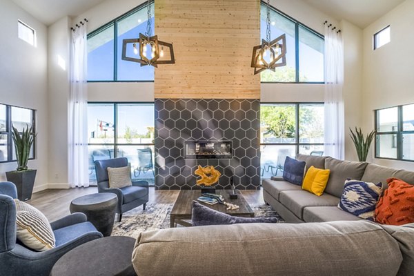 Modern living room with large windows and stylish furniture featuring a fireplace