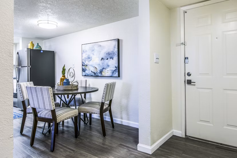 Elegant dining room with modern lighting fixtures at Stride West Apartment