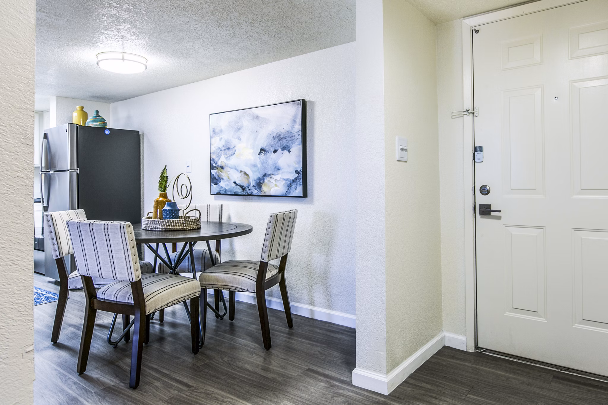 Elegant dining room with modern lighting fixtures at Stride West Apartment