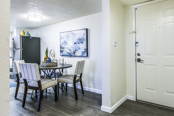 Elegant dining room with modern lighting fixtures at Stride West Apartment