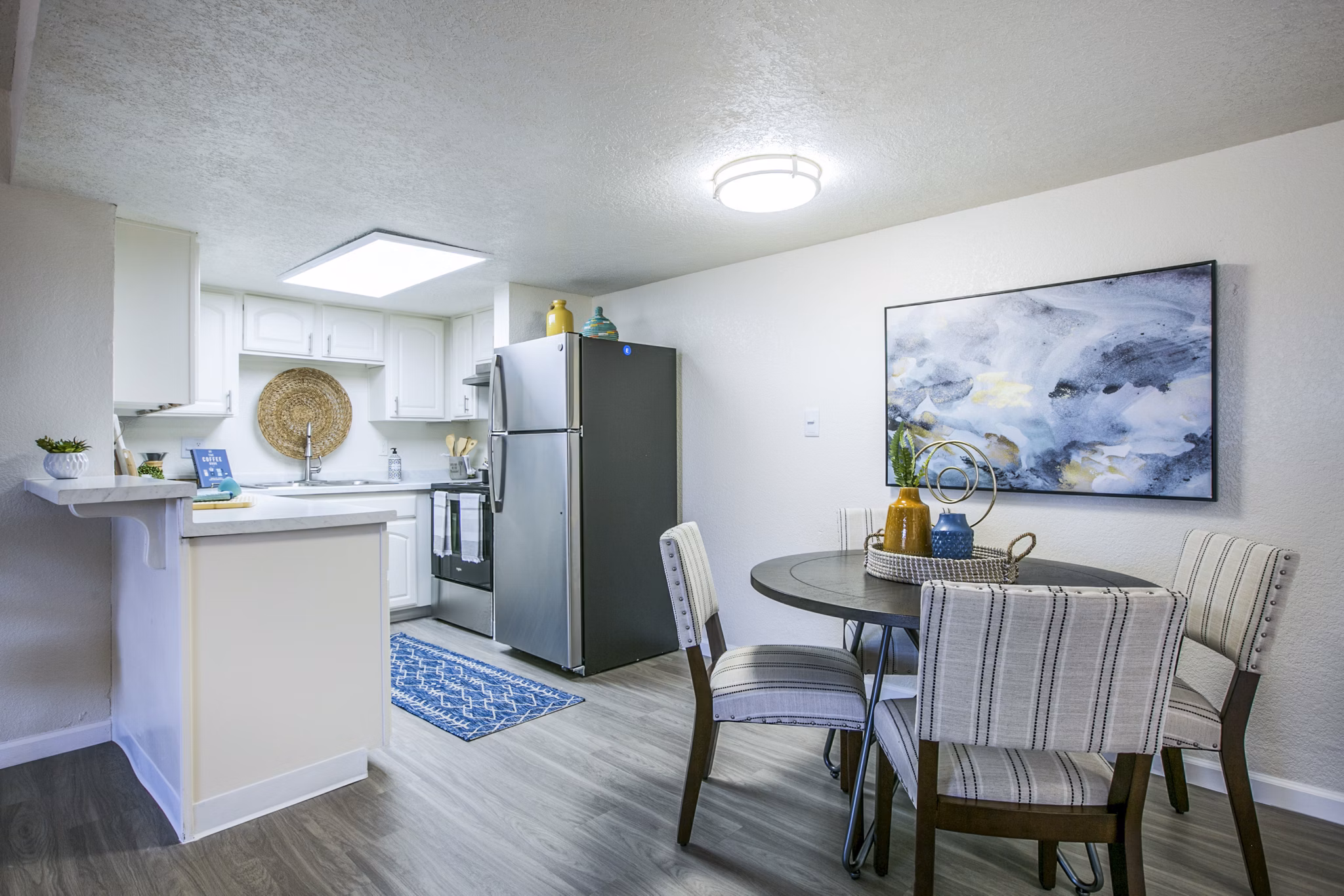 Dining room featuring modern table set and chic lighting in Stride West Apartments, San Diego