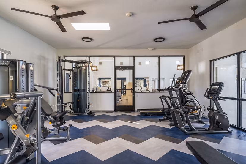 Fitness center with state-of-the-art equipment at Stride West Apartments, offering a modern space for residents' exercise routines