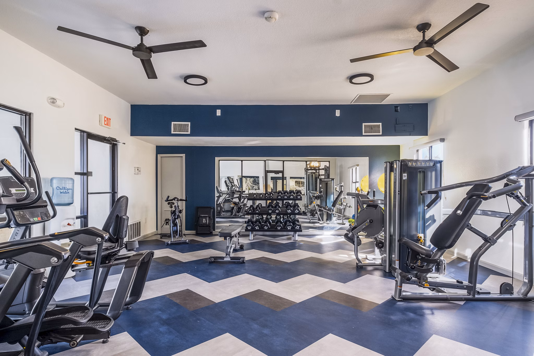 Modern fitness center with state-of-the-art equipment at Stride West Apartments