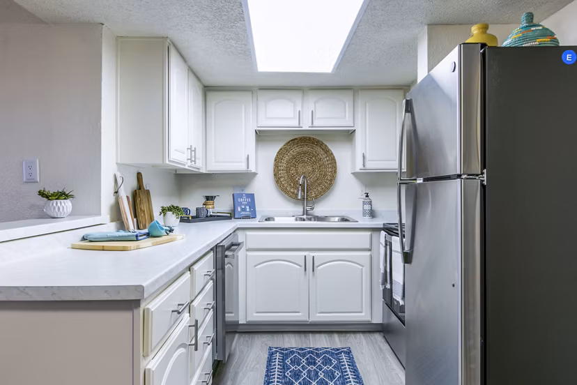 Stride West Apartment: Modern kitchen with stainless steel appliances and sleek countertops in luxury environment