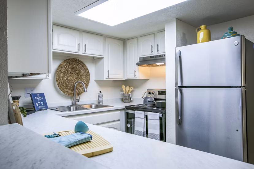 Modern kitchen with stainless steel appliances in Stride West Apartment