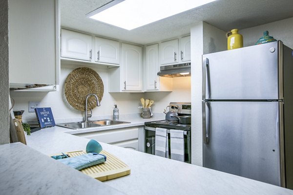 Modern kitchen with stainless steel appliances in Stride West Apartment