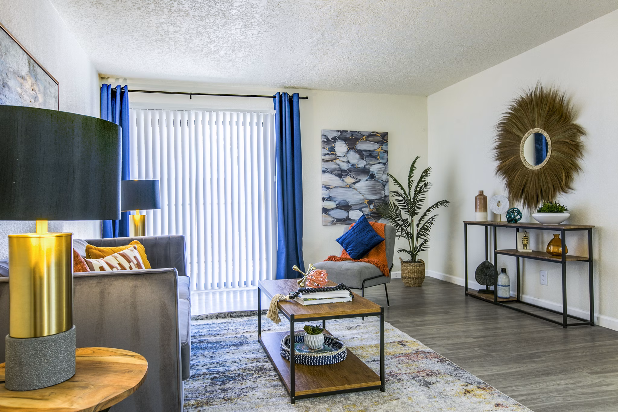 Spacious living room with modern decor and abundant natural light at Stride West Apartments