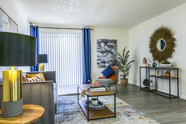 Spacious living room with modern decor and abundant natural light at Stride West Apartments