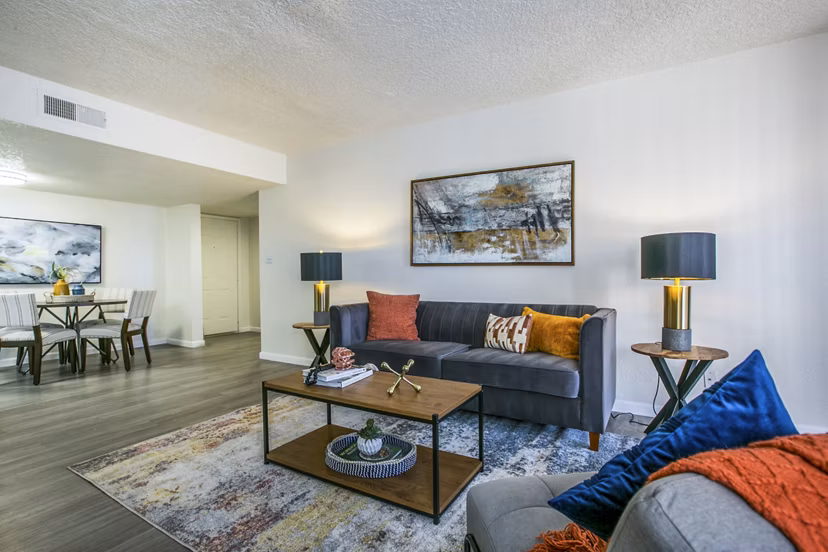 Spacious living room with modern furnishings in Stride West Apartments, a luxury property by Greystar