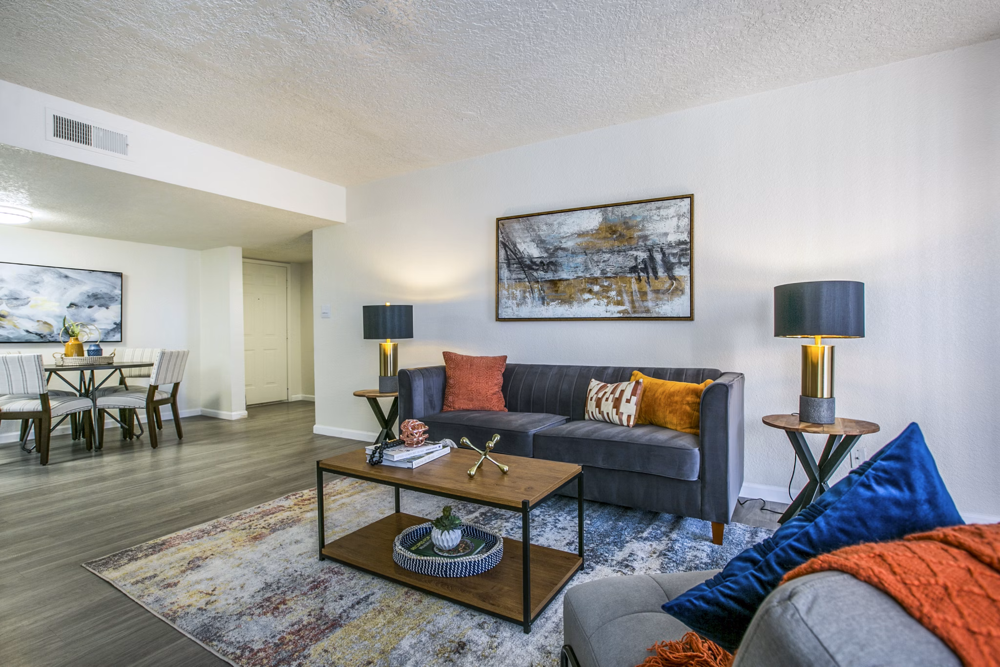 Spacious living room with modern furnishings in Stride West Apartments, a luxury property by Greystar