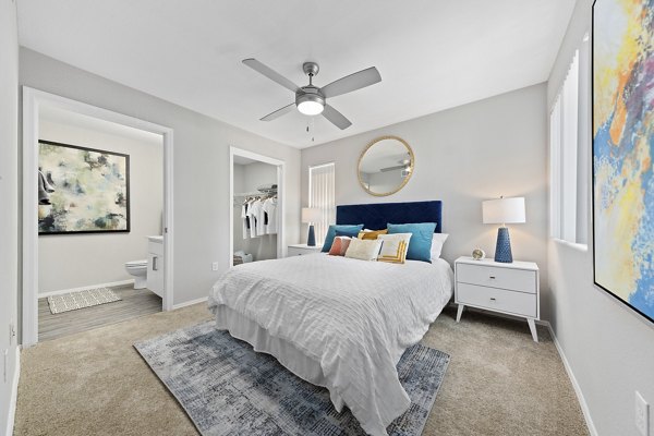 Elegant bedroom with plush bedding and modern decor at Morada Grande Apartments