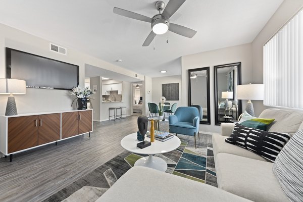 Modern living room with ceiling fan and wall-mounted TV in luxury apartment