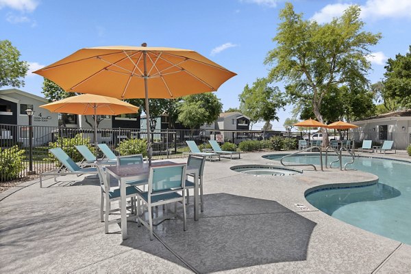 Modern outdoor pool with lounge chairs at Morada Grande Apartments, offering luxury living experience