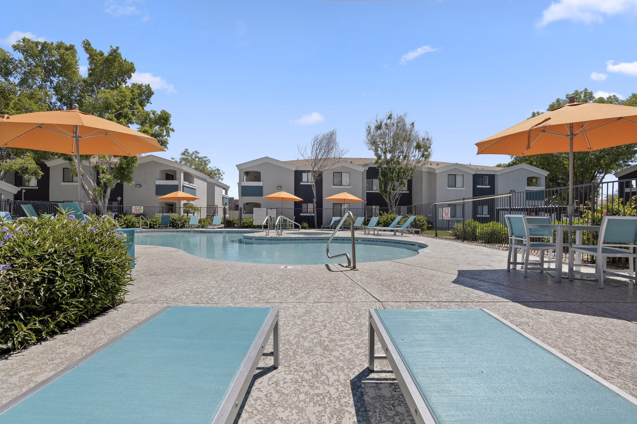 Luxurious poolside retreat at Morada Grande Apartments with tranquil water features and comfortable loungers