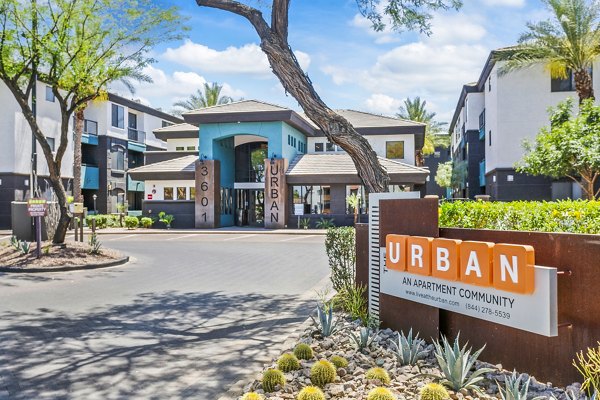 Entrance to Urban luxury apartments featuring landscaped grounds and community sign