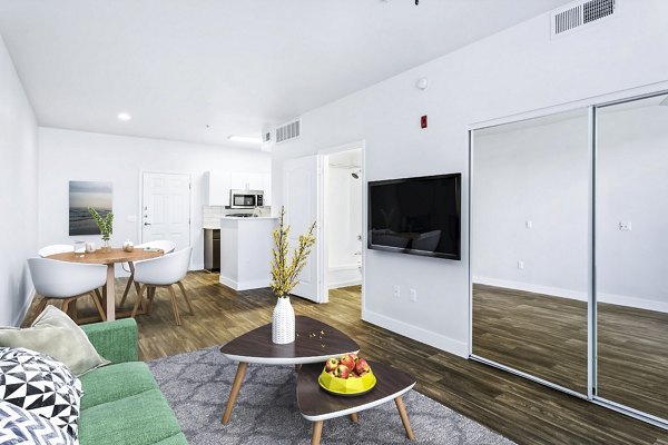 Stylish living room featuring contemporary design and large windows at The Urban Apartments, Greystar luxury apartments