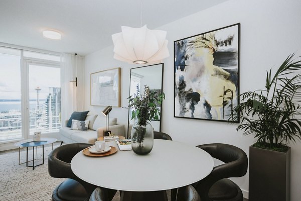 Dining room featuring elegant lighting and modern decor at REN Apartments