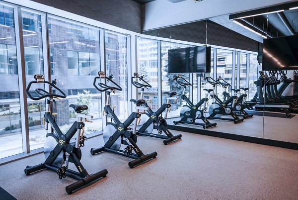 Modern fitness center with state-of-the-art equipment at REN Apartments, offering residents a premium workout experience
