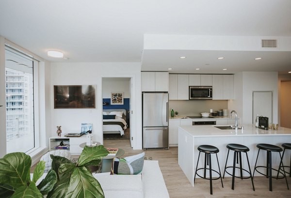 Kitchens with modern appliances and sleek cabinetry at REN Apartments offering luxury living