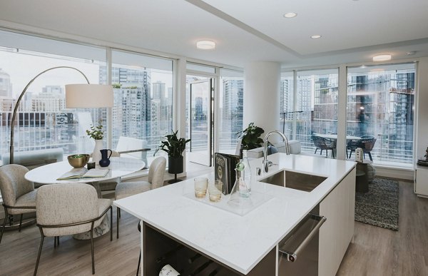 Modern kitchen featuring stainless steel appliances in REN Apartments