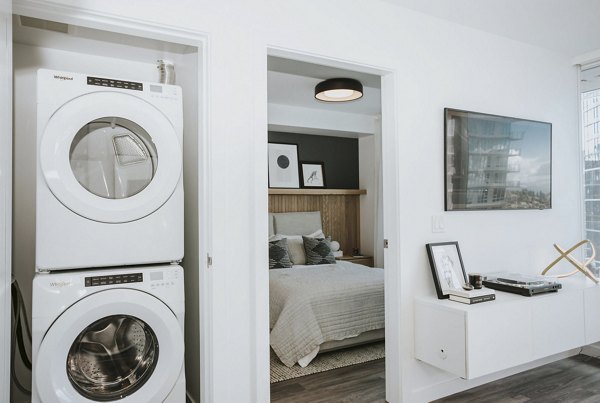 Laundry room with modern washers and dryers in REN Apartments