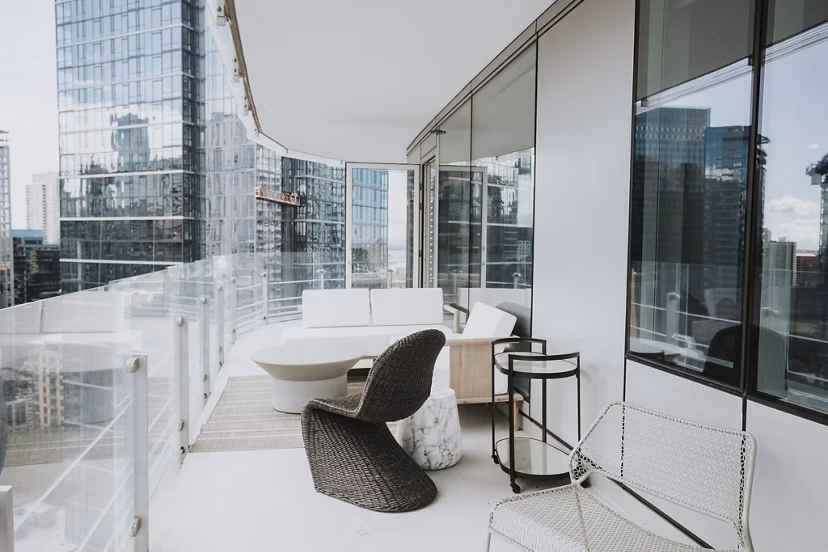 Outdoor patio with stylish seating and lush greenery at REN Apartments, perfect for relaxation and entertaining