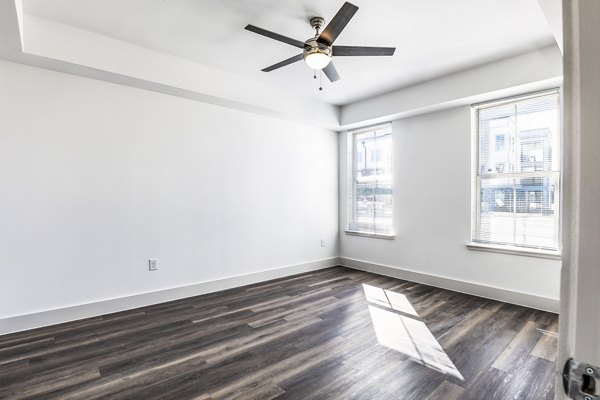 Cozy bedroom with modern decor at Nexus at Goodnight Ranch Apartments