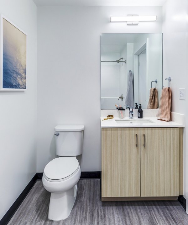 Modern bathroom featuring sleek fixtures and ample vanity space at Union on Broadway Apartments