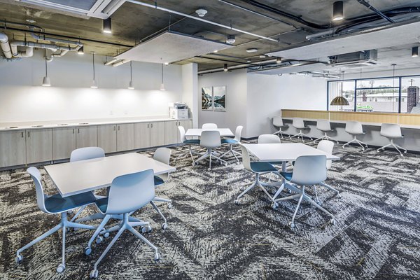 Clubhouse study area featuring modern seating and workstations at Union on Broadway Apartments