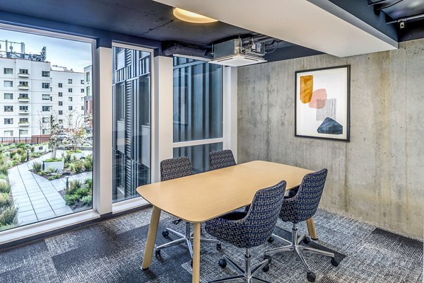 Clubhouse study area with modern seating and study desks at Union on Broadway Apartments, offering a luxurious and productive environment