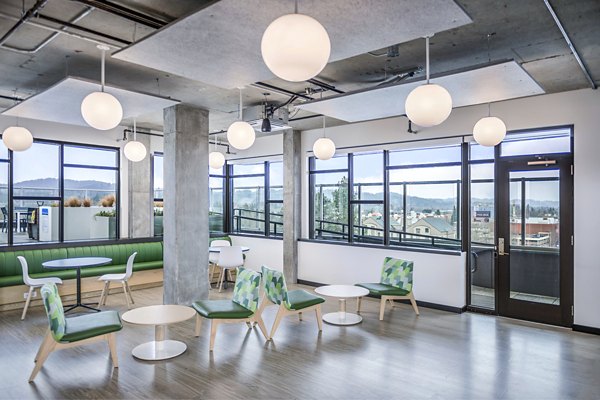 Clubhouse study area with cozy seating and ample lighting at Union on Broadway Apartments