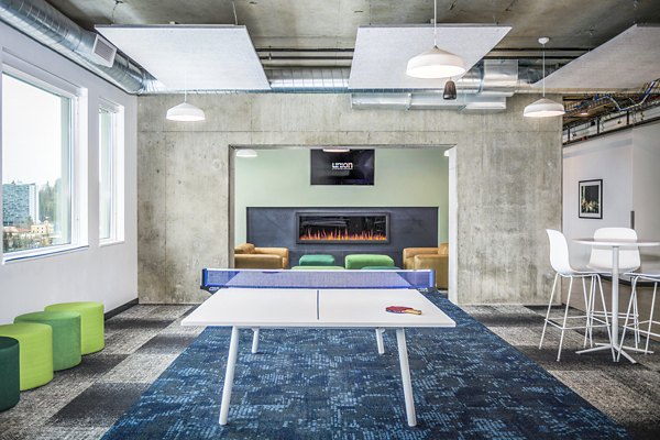 Clubhouse game room featuring pool table and lounge seating at Union on Broadway Apartments