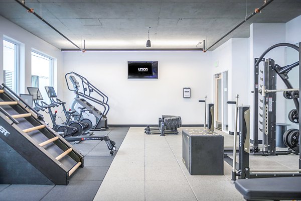 Fully-equipped fitness center with modern gym equipment at Union on Broadway Apartments