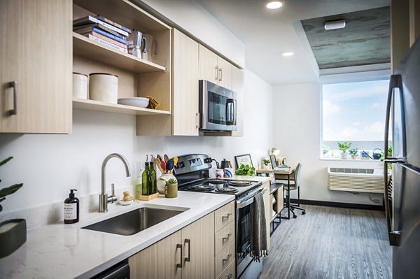 Modern kitchen with stainless steel appliances at Union on Broadway Apartments