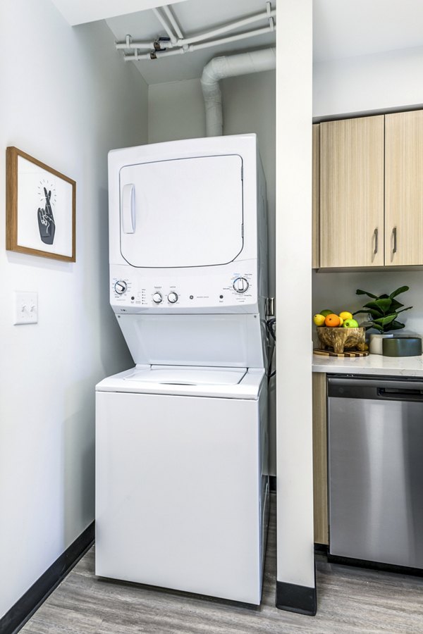 Modern laundry room with high-efficiency washers and dryers at Union on Broadway Apartments