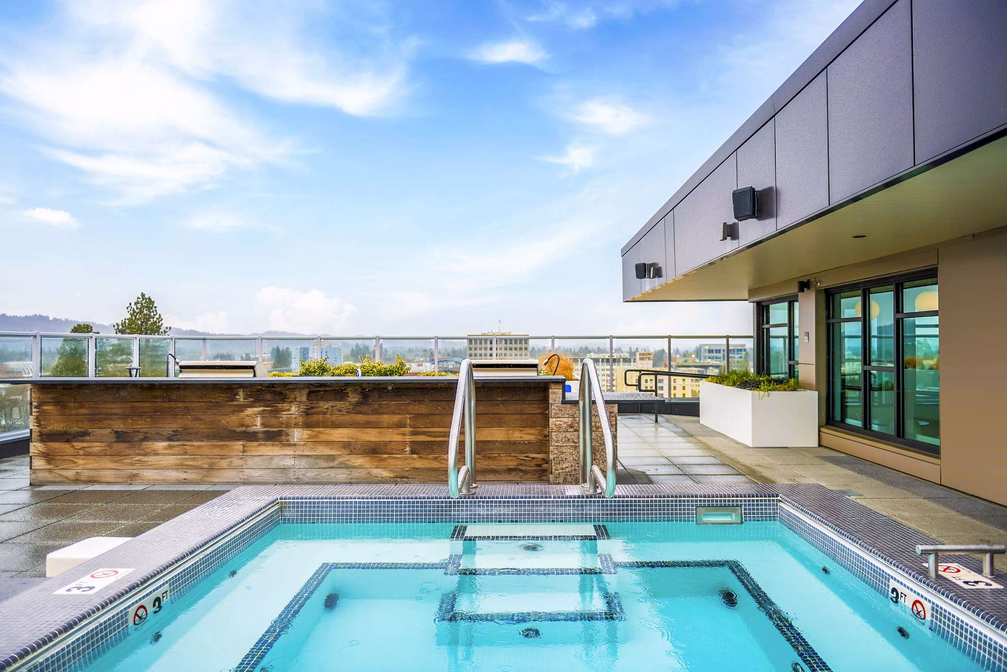 Rooftop pool with city backdrop at Union on Broadway Apartments