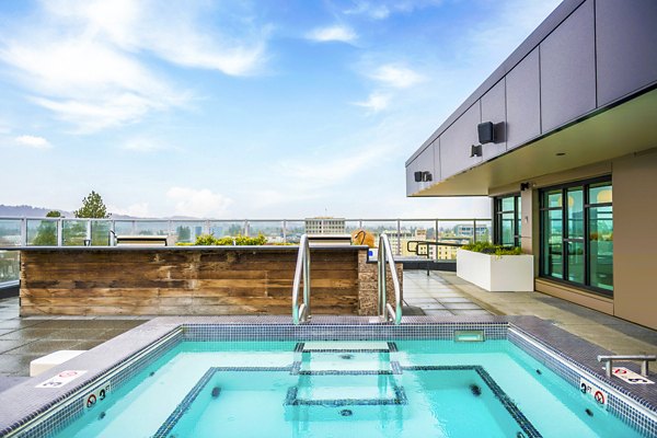 Rooftop pool with city backdrop at Union on Broadway Apartments