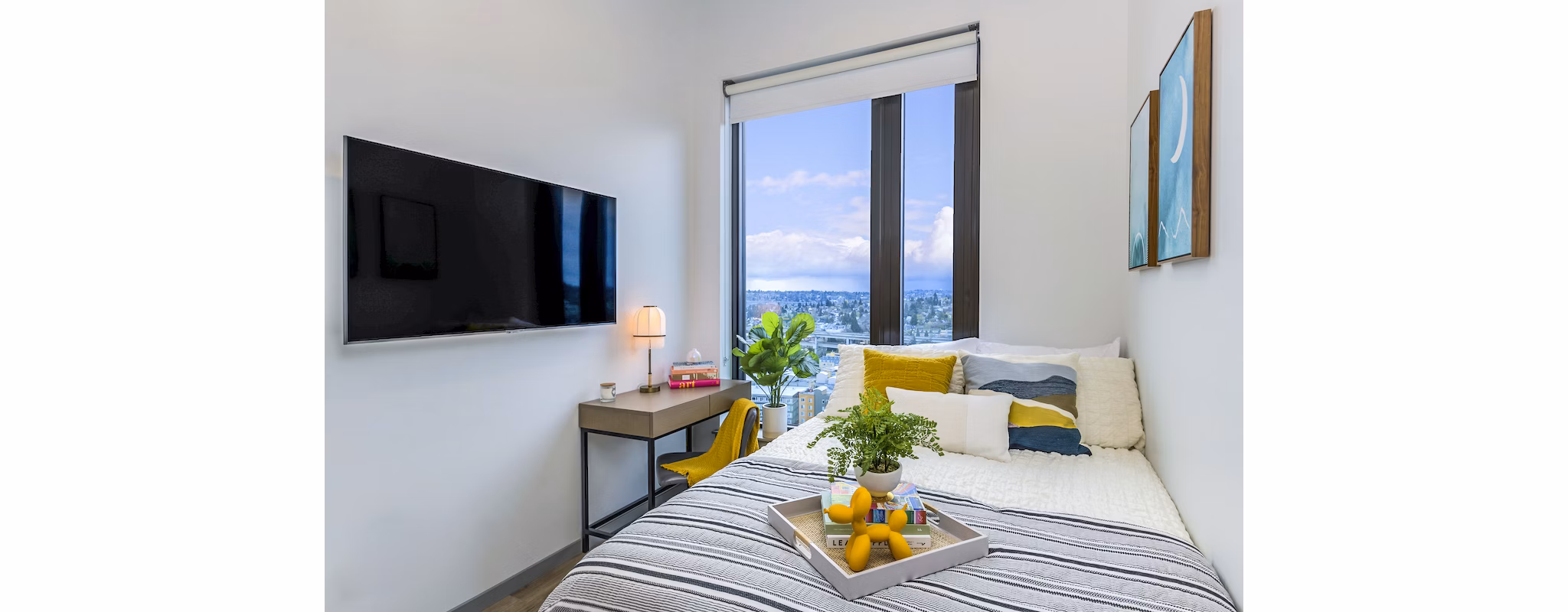 Cozy bedroom with modern decor in The Accolade Apartments, featuring stylish furnishings and ample natural light